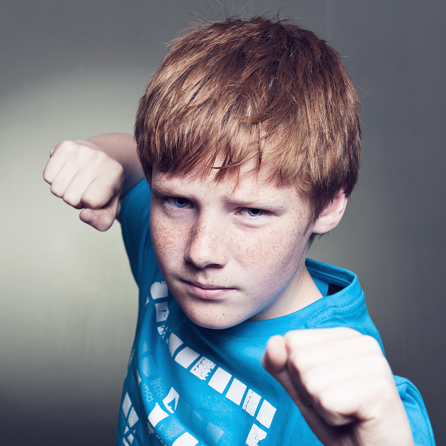 A boy raising his fists.