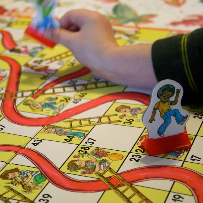 Children playing the game Chutes and Ladders.