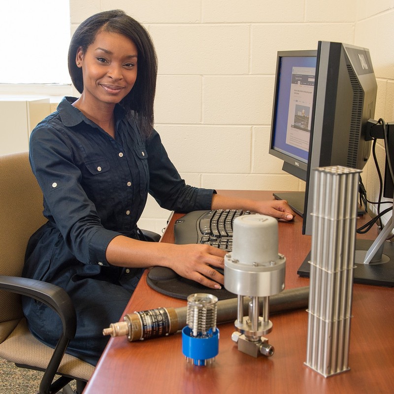 J’Tia Taylor sits at her desk. She is a nonproliferation technical specialist at an engineering research laboratory.