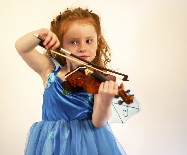 A young girl practicing the violin.