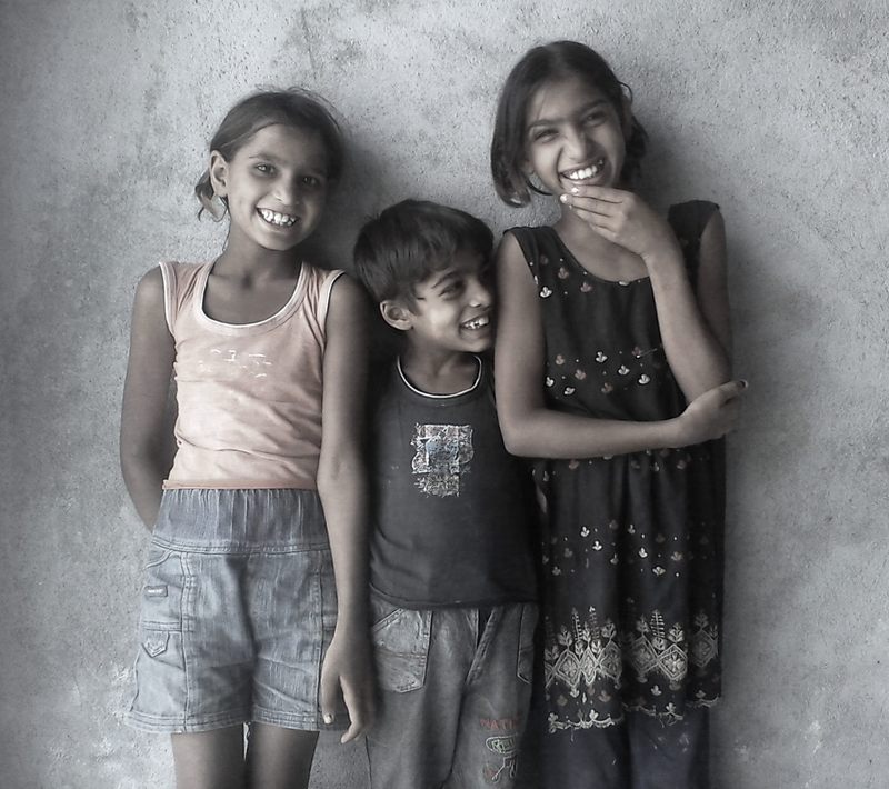 Three smiling siblings.
