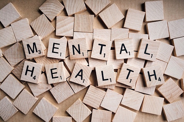 An image of small wooden tiles that spell out "Mental Health".