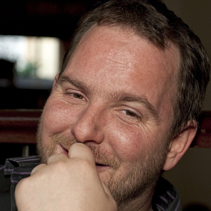 A European-American man shows a warm smile.