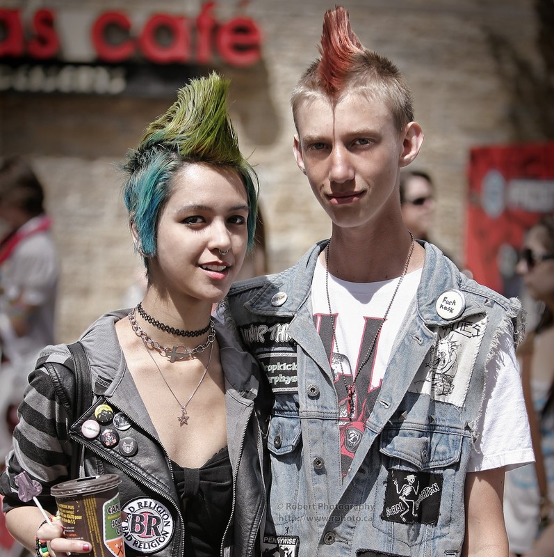 Two teens with colorful Mohawk hairstyles and punk rock clothes