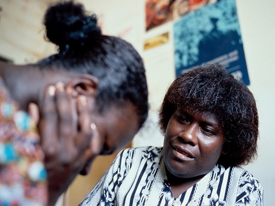 A therapist sits across from a patient in a counseling session.