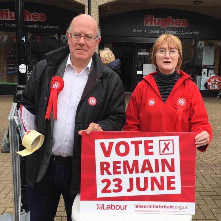 Two people holding a UK vote sign