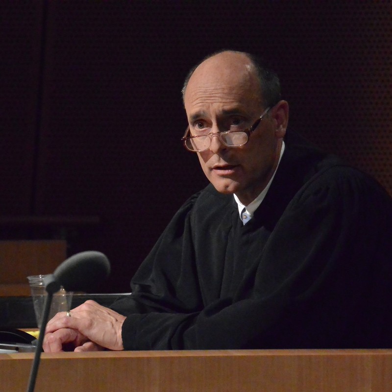 A judge dressed in a traditional black robe.