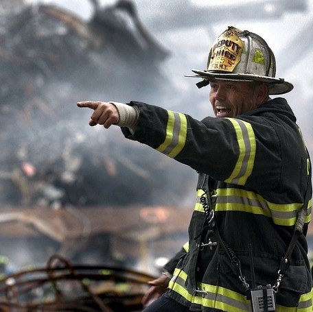 A firefighter calling out and pointing during a call.