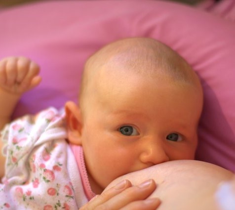 An infant breastfeeds.