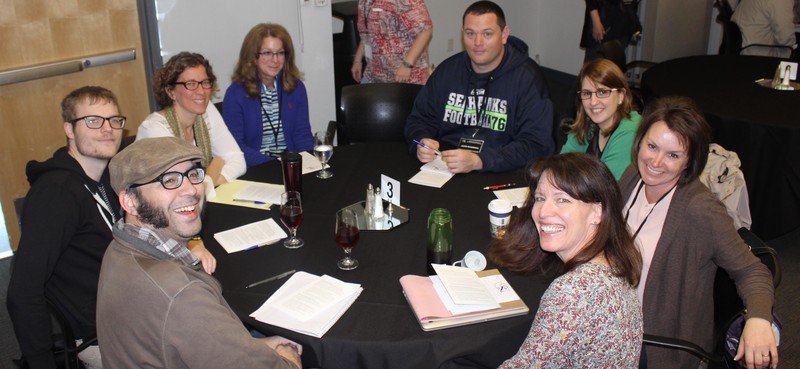 A group of psychology instructors participating in a round-table discussion.