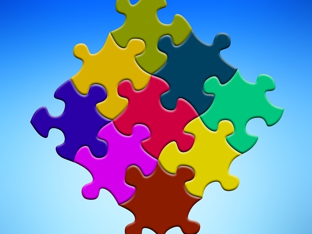 Image of puzzle pieces all different colors, all fitting together.