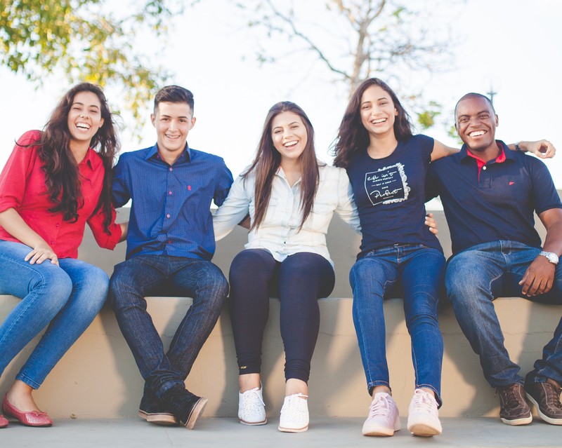 An image of young people smiling at the camera