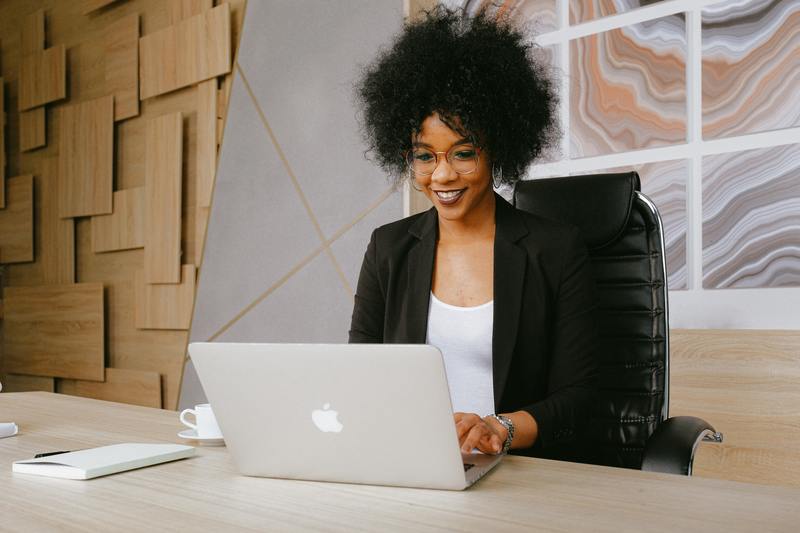 A young woman sits a computer