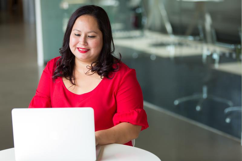 A young woman sitting at a computer