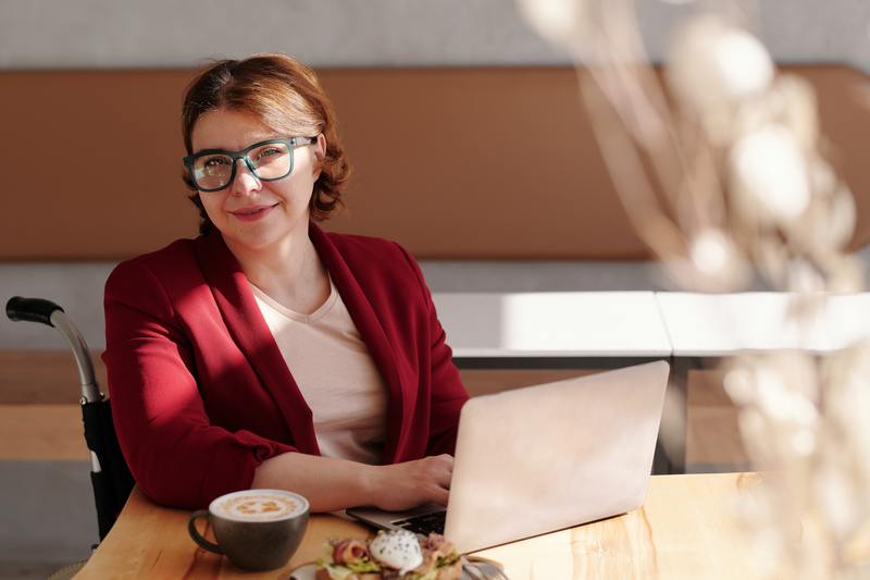 Middle aged woman with a computer and a coffee