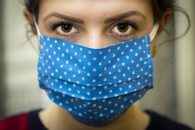 A woman wearing a face mask, with only her eyes uncovered